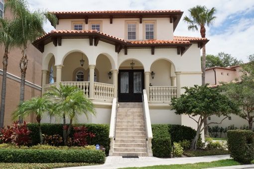 Tampa Property Management Serving Western Hillsborough Eastern - a white two story mediterranean style home near where you can hire